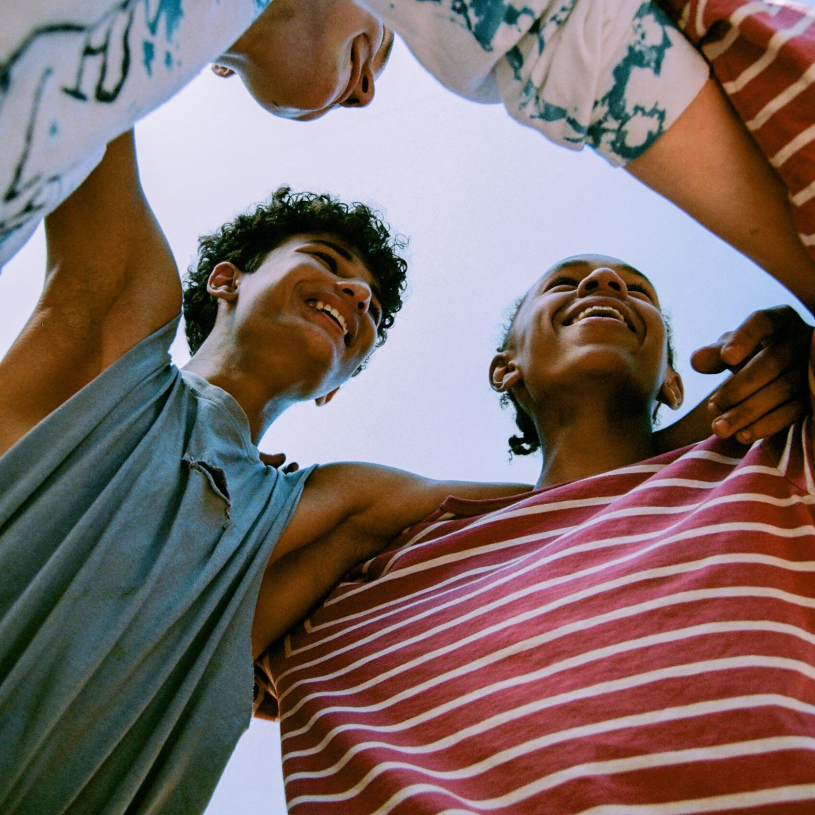 Happy Young Teenage Boys Hugging Each Other